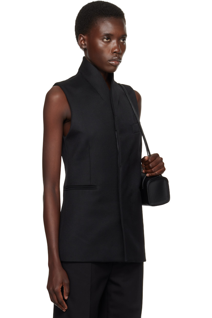 Wool twill vest.

· Shawl lapel
· Button closure
· Welt pockets
· Full cotton twill lining

Supplier color: Black