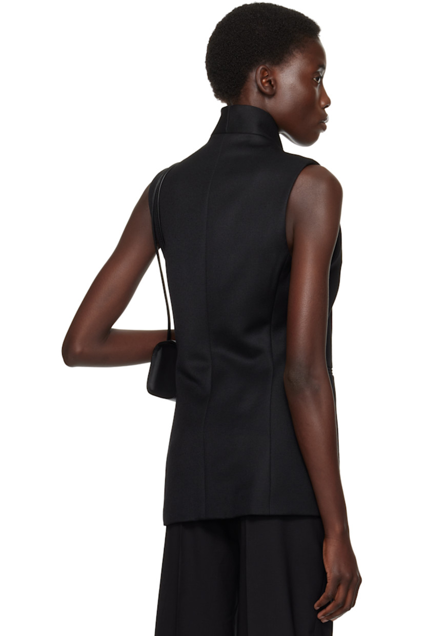 Wool twill vest.

· Shawl lapel
· Button closure
· Welt pockets
· Full cotton twill lining

Supplier color: Black