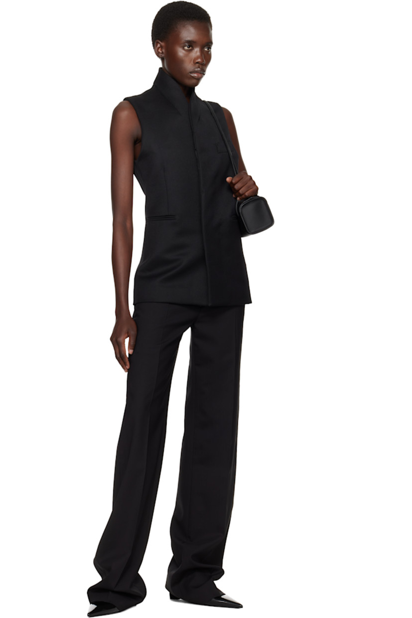 Wool twill vest.

· Shawl lapel
· Button closure
· Welt pockets
· Full cotton twill lining

Supplier color: Black