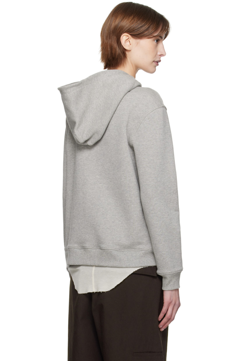 French terry hoodie.

· Eyelets at hood
· Zip closure
· Padded satin logo appliqué at front
· Patch pockets
· Rib-knit hem and cuffs

Supplier color: Grey