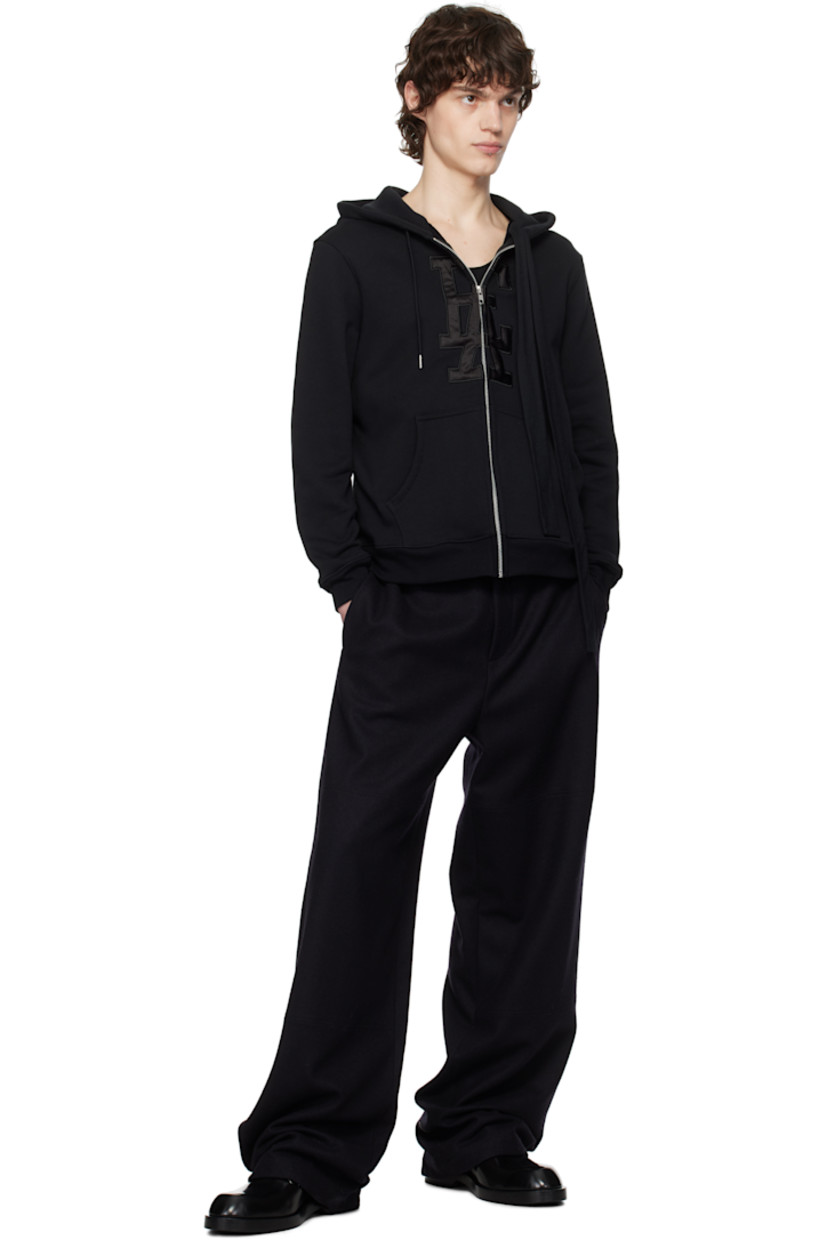 French terry hoodie.

· Drawstring at hood
· Zip closure
· Padded satin logo appliqué at front
· Patch pockets
· Rib-knit hem and cuffs

Supplier color: Black