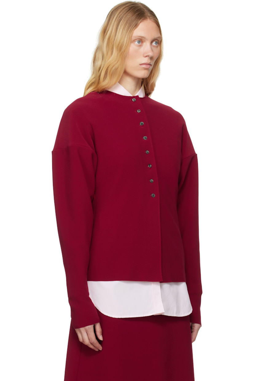 Double-faced stretch polyester bonded crêpe cardigan. Raw edges throughout. 

· Round neck
· Button closure
· Dropped shoulders 

Supplier color: Ruby