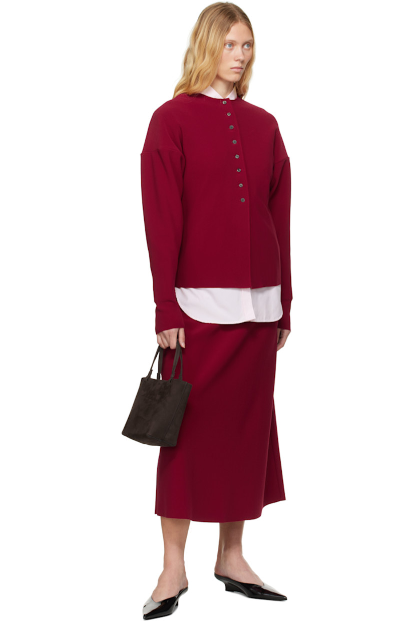 Double-faced stretch polyester bonded crêpe cardigan. Raw edges throughout. 

· Round neck
· Button closure
· Dropped shoulders 

Supplier color: Ruby