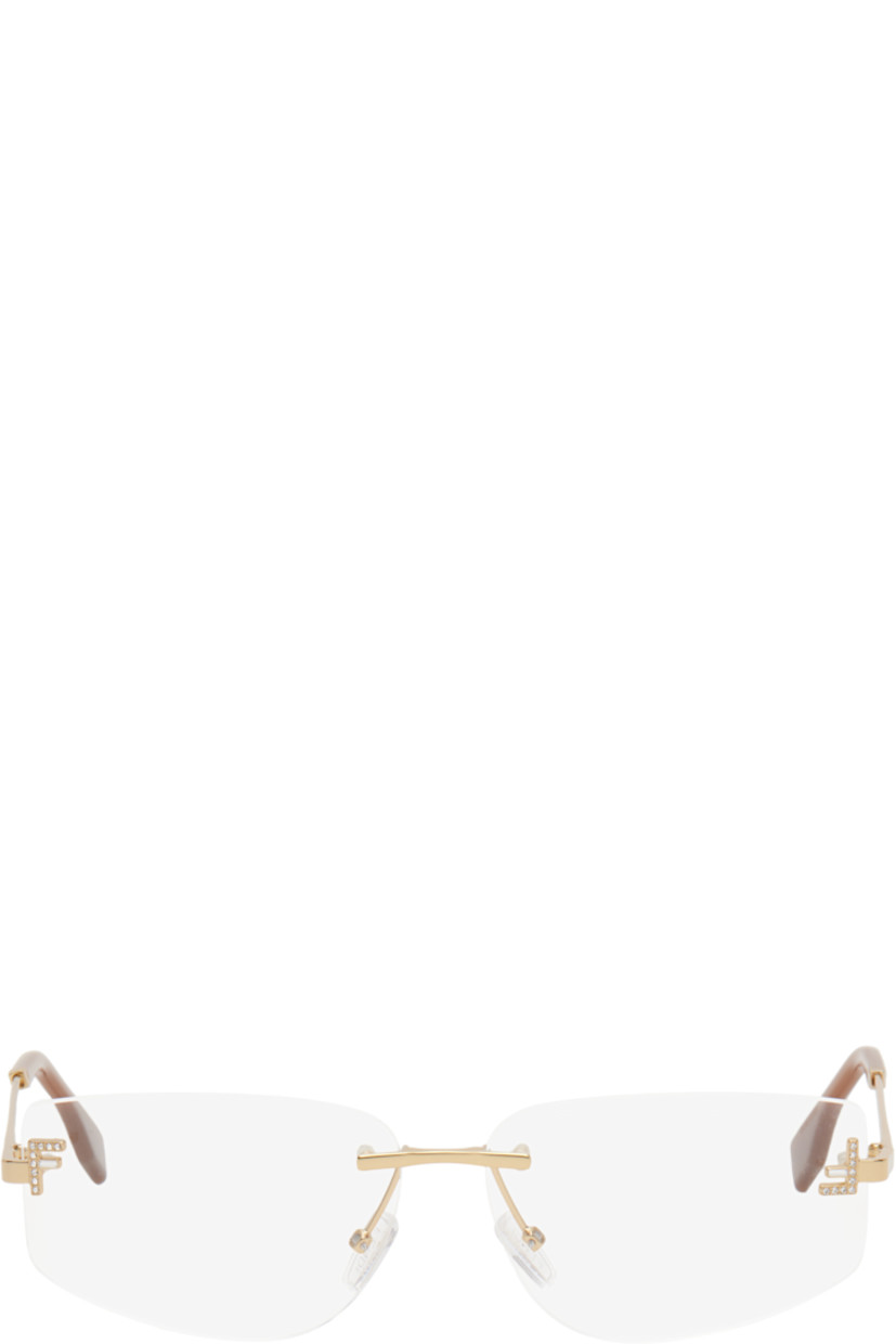 Cat-eye rimless metal-frame optical glasses in gold tone. 

· Adjustable rubber nose pads
· Crystal-cut logo at face 
· Logo embossed at temples
· Acetate temple tips in brown
· Includes pouch 
· Size: 58.12 135 

Supplier color: Shiny endura gold