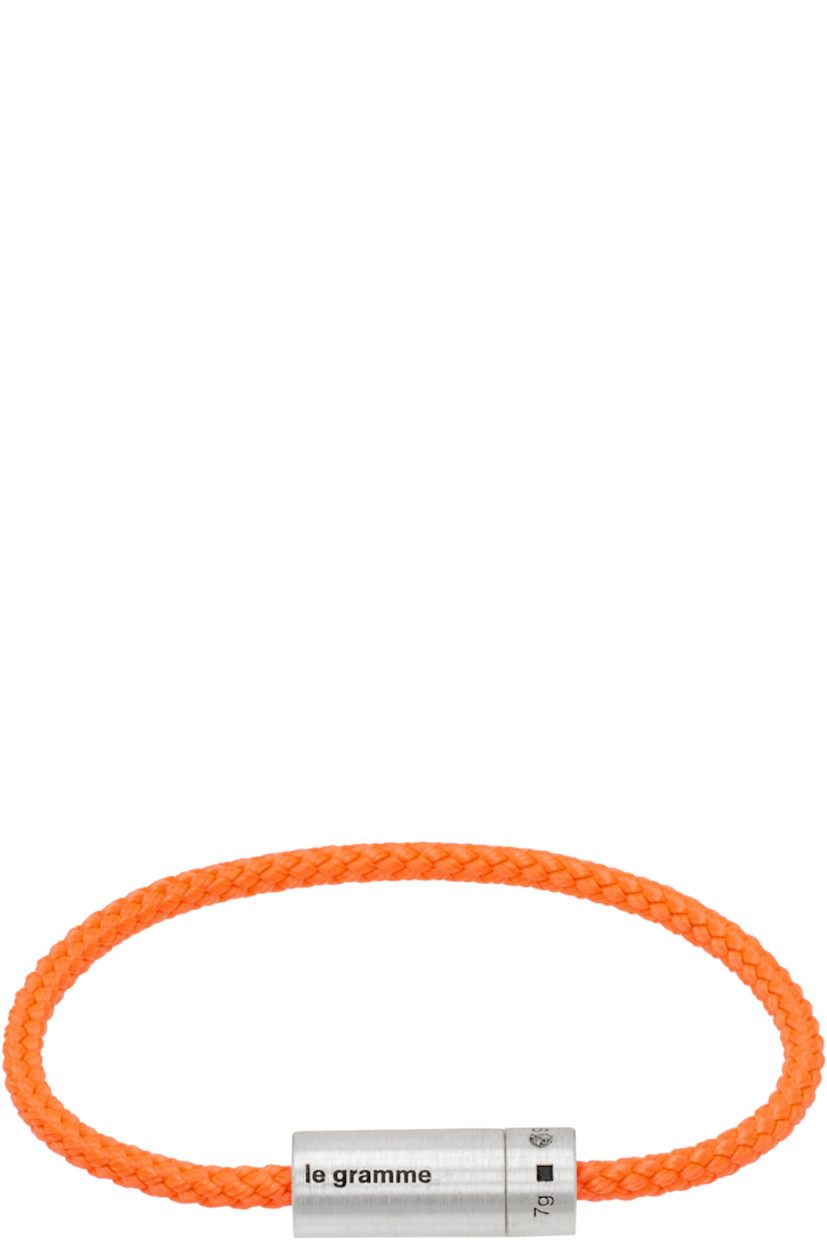Braided cord bracelet in orange. Logo-engraved brushed recycled sterling silver screw fastening.

Supplier color: Orange