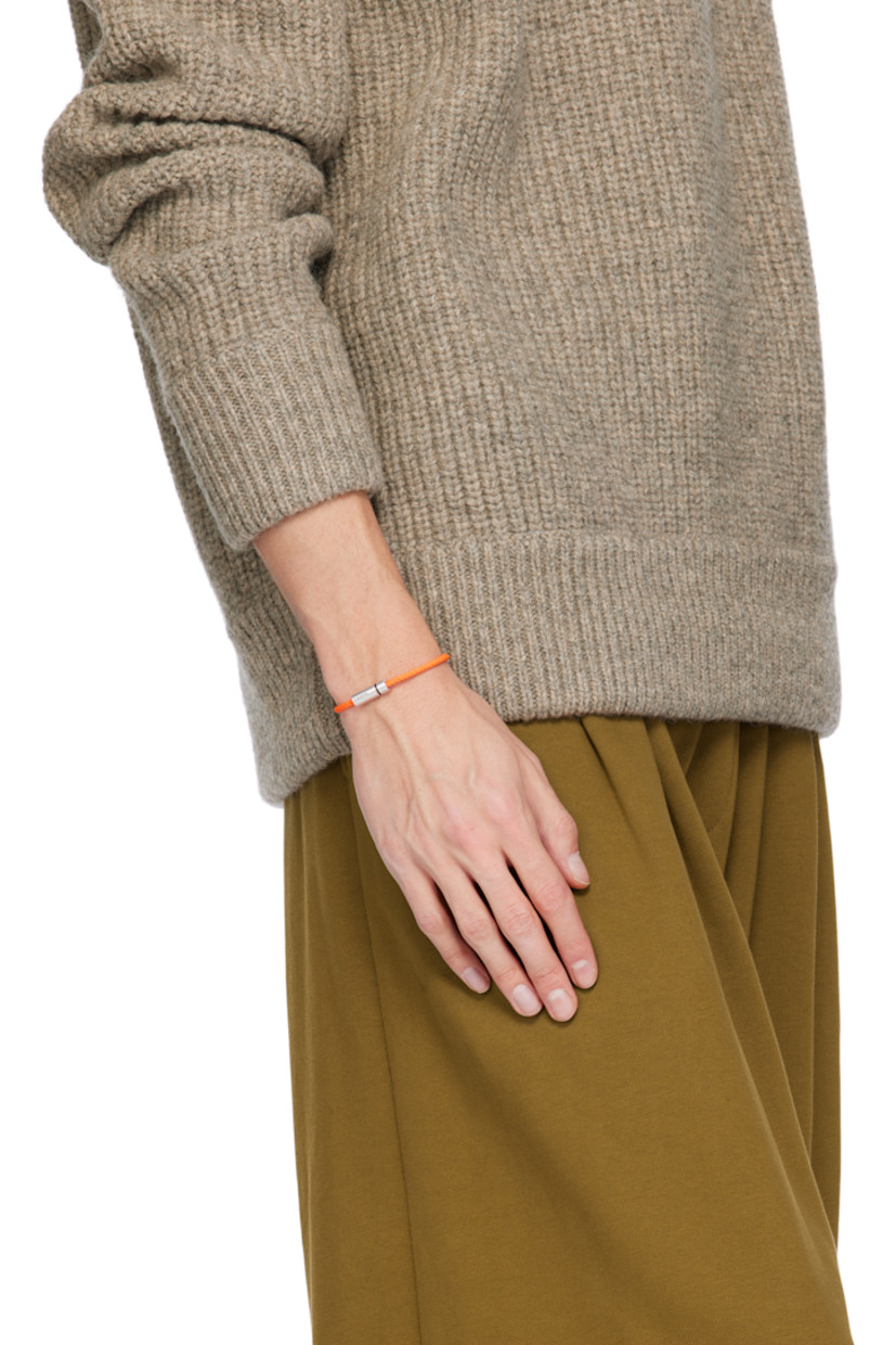 Braided cord bracelet in orange. Logo-engraved brushed recycled sterling silver screw fastening.

Supplier color: Orange