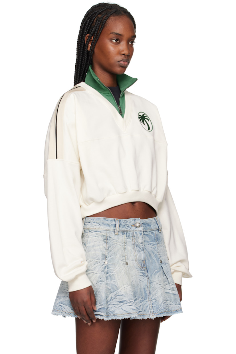 French terry and polyester interlock jersey sweatshirt. 

· Paneled construction
· Rib-knit stand collar, hem, and cuffs
· Half-zip closure
· Logo embroidered at chest
· Cropped hem
· Logo flag at side seam
· Striped trim at shoulders
· Yoke sleeves

Supplier color: Off white/Forest green