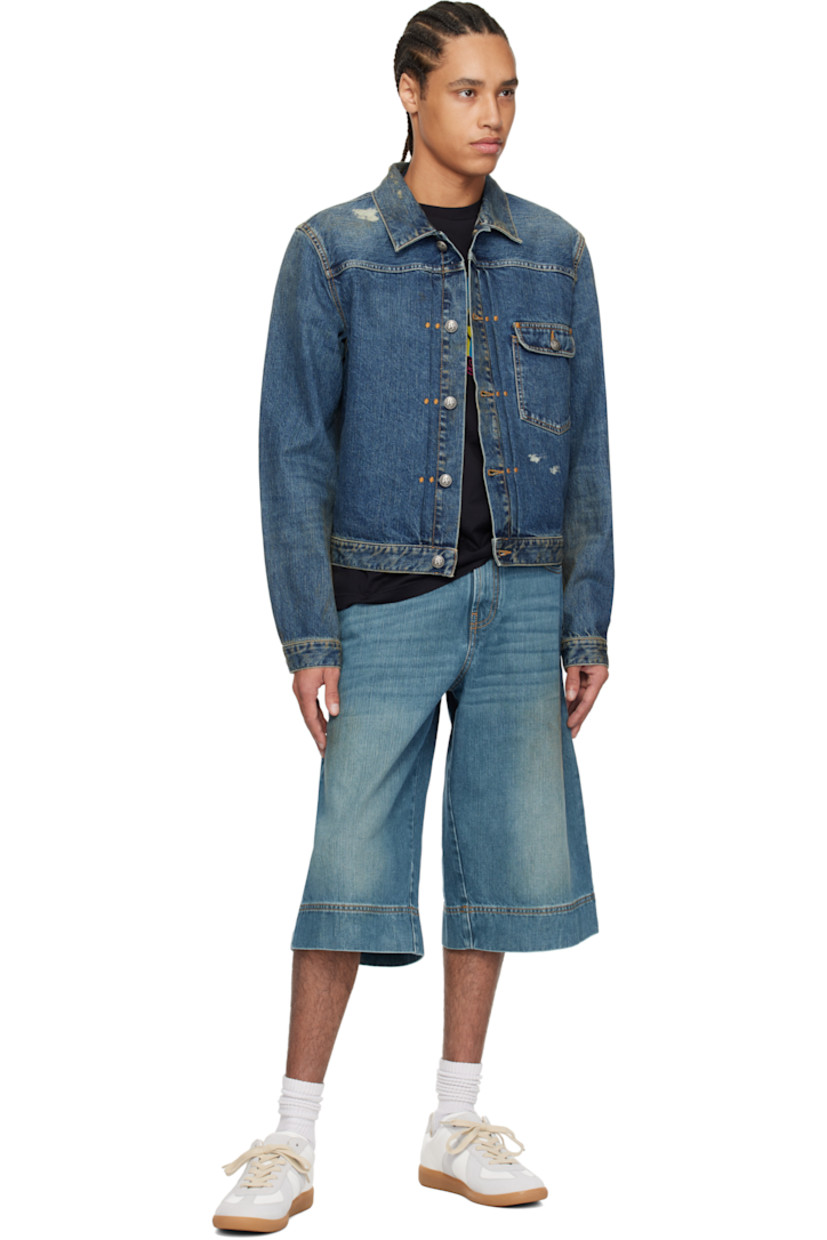 Non-stretch denim jacket. Fading, discoloration, and subtle distressing throughout. 

· Spread collar
· Button closure
· Flap pocket
· Single-button barrel cuffs
· Twin pleats at back yoke
· Logo printed at back
· Cinch tab at back waistband
· Logo-engraved antiqued silver-tone hardware
· Contrast stitching in tan

Supplier color: Blue/Light blue