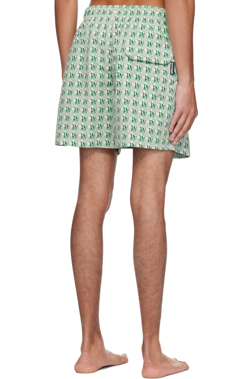 Polyester taffeta swim shorts. Logo graphic pattern printed throughout.

· Drawstring at elasticized waistband
· Three-pocket styling
· Logo flag and eyelet vent at back pocket
· Partial mesh lining

Supplier color: Green/Ivory