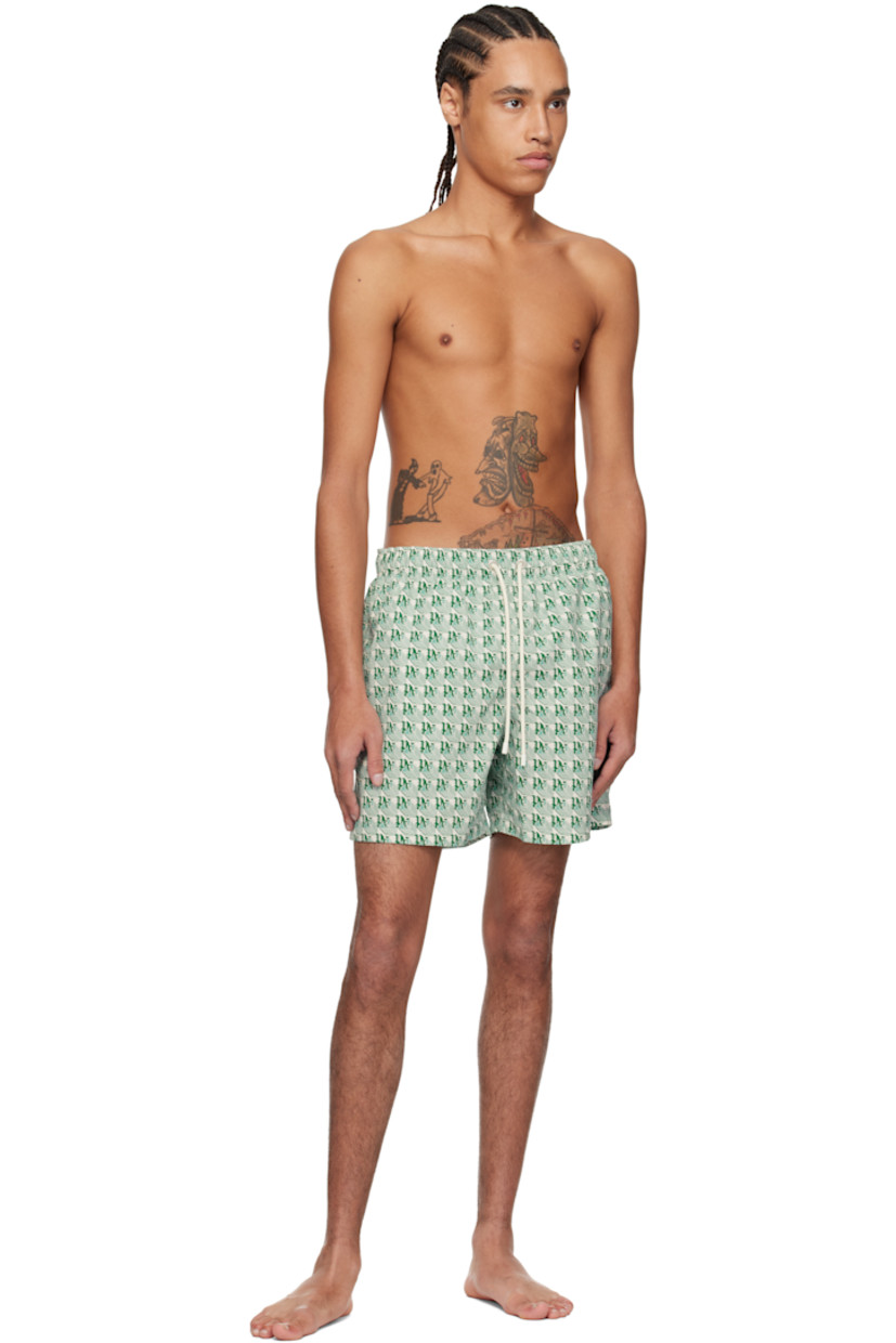 Polyester taffeta swim shorts. Logo graphic pattern printed throughout.

· Drawstring at elasticized waistband
· Three-pocket styling
· Logo flag and eyelet vent at back pocket
· Partial mesh lining

Supplier color: Green/Ivory