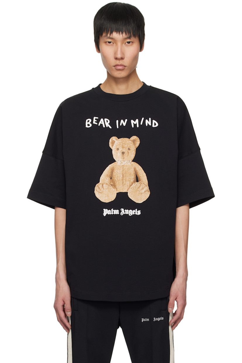 Cotton jersey T-shirt. 

· Rib-knit crewneck
· Logo, graphic, and text bonded at front 
· Logo flag at side seam
· Dropped shoulders

Supplier color: Black/Brown