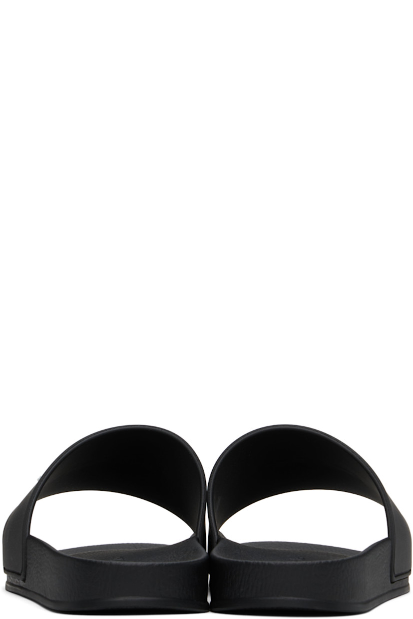 Rubber pool slides in black.

· Open toe
· Logo embossed at vamp
· Logo embossed at molded footbed
· Treaded rubber sole

Supplier color: Black/White