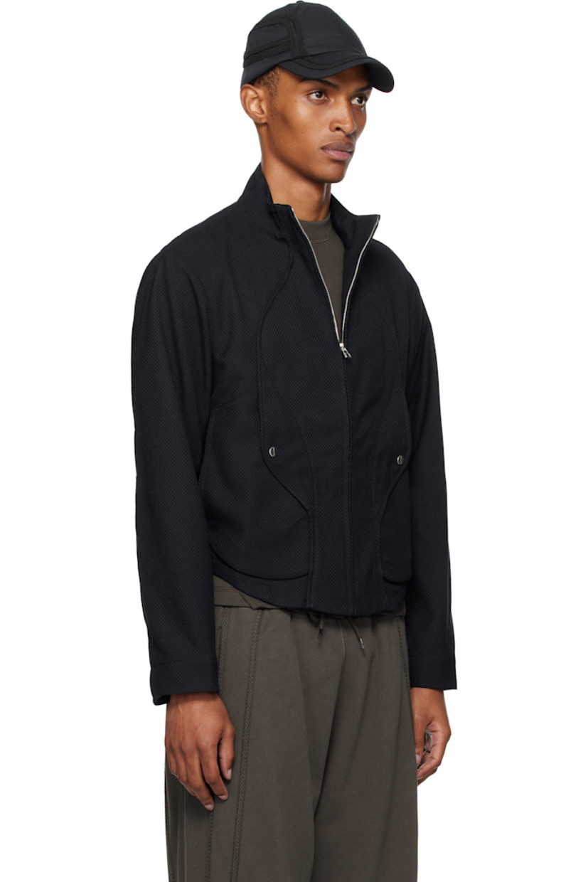 Stretch waffle-woven jacket. 

· Paneled construction
· Stand collar with bead hardware
· Zip closure
· Welt pockets and flap pockets at waist
· Inverted box pleat at back
· Unlined
· Silver-tone hardware

Supplier color: Lapis blue