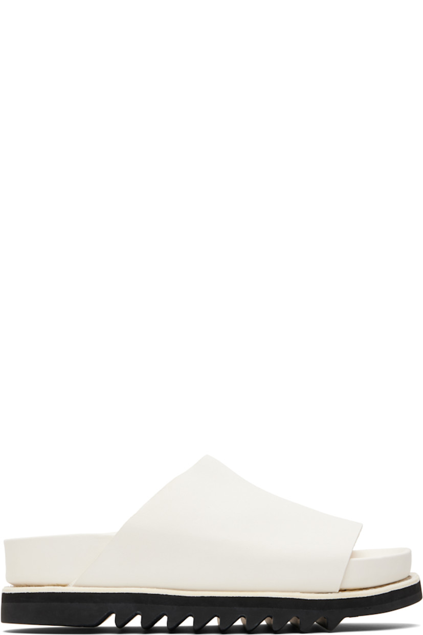 Piece-dyed grained calfskin slip-on sandals.

· Open toe
· Logo embossed at molded leather footbed 
· Goodyear welt
· Vibram® Gumlite® treaded rubber sole

Supplier color: White