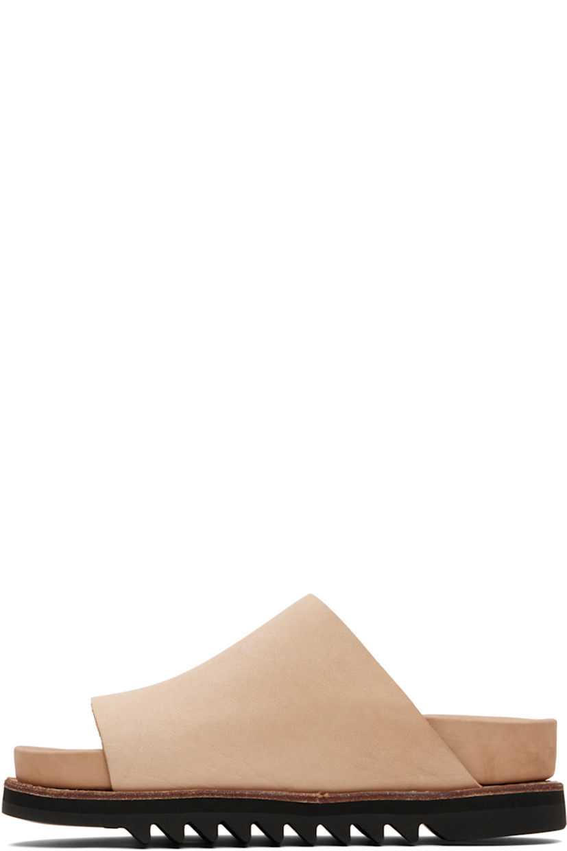 Piece-dyed grained calfskin slip-on sandals.

· Open toe
· Logo embossed at molded leather footbed 
· Goodyear welt
· Vibram® Gumlite® treaded rubber sole

Supplier color: Sand