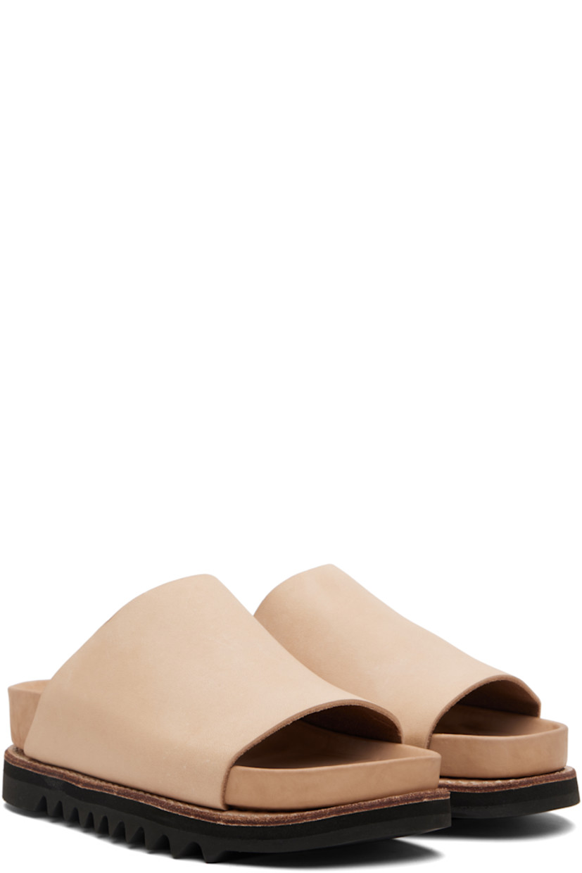 Piece-dyed grained calfskin slip-on sandals.

· Open toe
· Logo embossed at molded leather footbed 
· Goodyear welt
· Vibram® Gumlite® treaded rubber sole

Supplier color: Sand