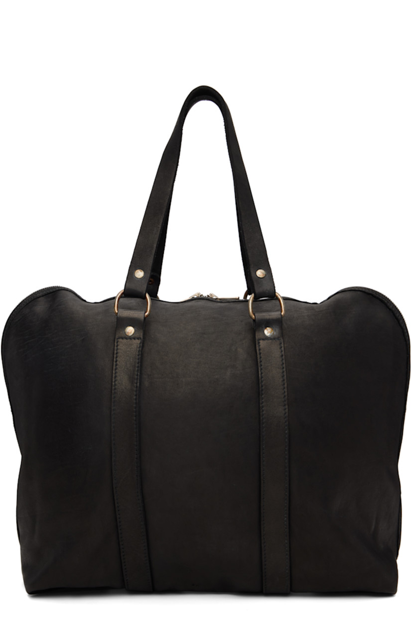 Grained horse leather duffle bag.

· Fixed carry handles 
· Press-stud tab at base 
· Two-way zip closure
· Zip pocket at interior 
· Unlined
· Logo-engraved antiqued silver-tone hardware
· H14" x W17" x D6.5"

Supplier color: Blkt