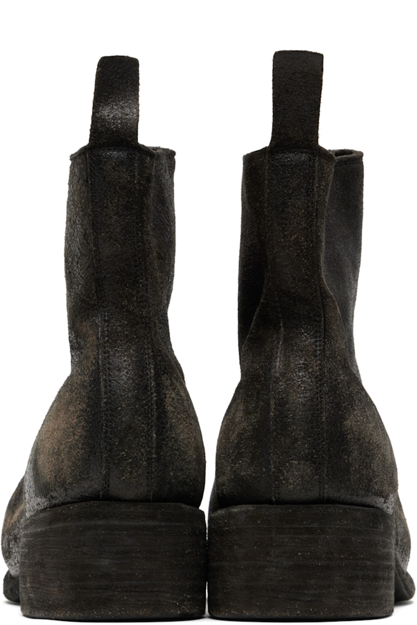 Ankle-high coated horse suede boots.

· Distressing throughout
· Zip closure at vamp
· Pull-tab at heel collar
· Full nubuck lining
· Topstitching at welt
· Stacked leather heel
· Leather sole
· Logo-engraved silver-tone hardware
· Heel: H1.75" 

Supplier color: Black