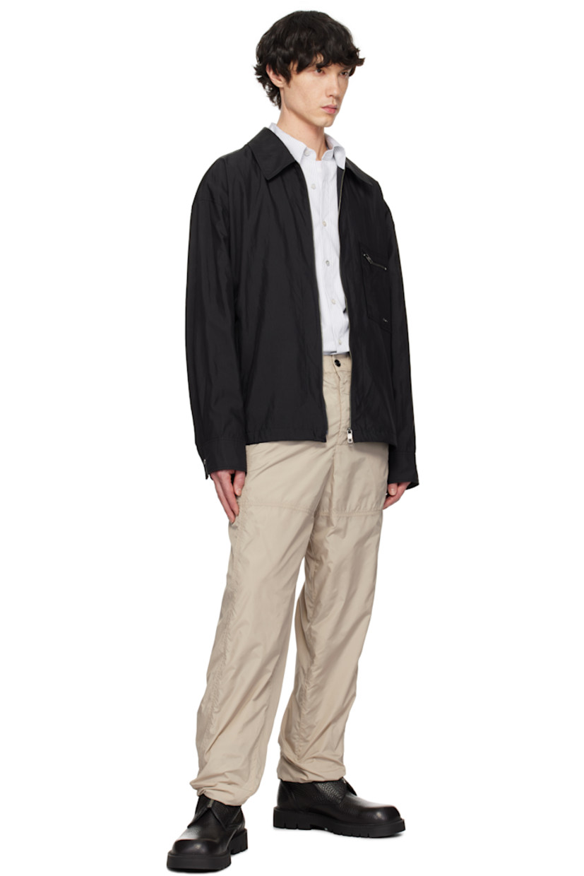 Lyocell- and nylon-blend taffeta jacket.

· Spread collar
· Two-way zip closure
· Zip pocket at chest
· Logo hardware at front
· Welt pockets
· Bungee-style drawstring at hem
· Adjustable press-stud barrel cuffs
· Logo hardware at back collar
· Pleats at back yoke

Supplier color: Black