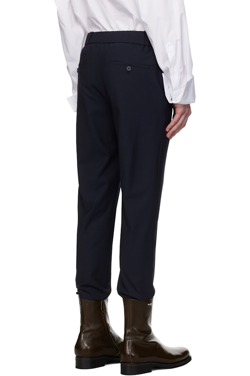 Plain-woven stretch wool-blend trousers.

· Belt loops 
· Concealed drawstring at partially elasticized waistband
· Four-pocket styling
· Zip fly
· Logo hardware at belt loop
· Rib-knit cuffs

Supplier color: Navy