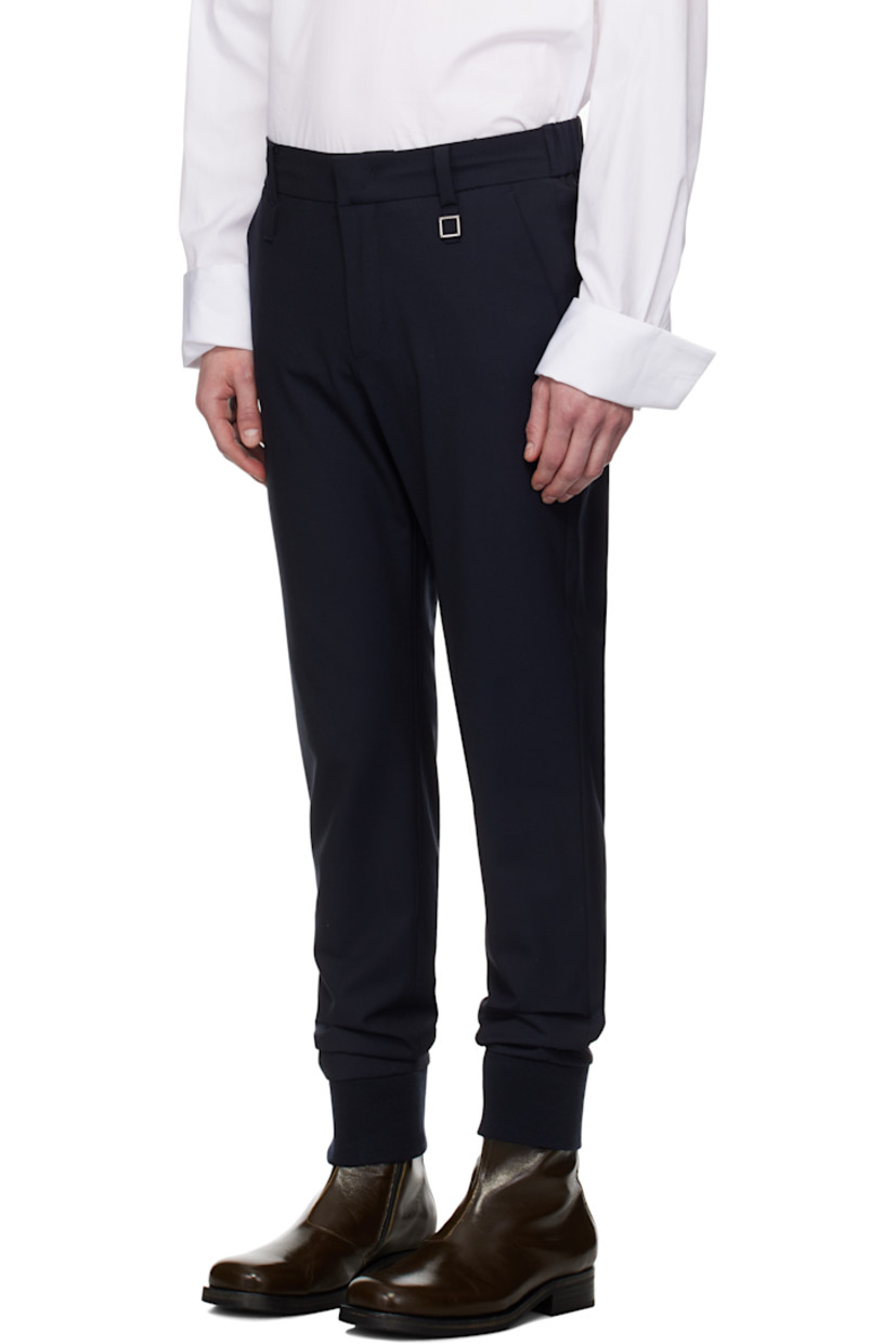 Plain-woven stretch wool-blend trousers.

· Belt loops 
· Concealed drawstring at partially elasticized waistband
· Four-pocket styling
· Zip fly
· Logo hardware at belt loop
· Rib-knit cuffs

Supplier color: Navy