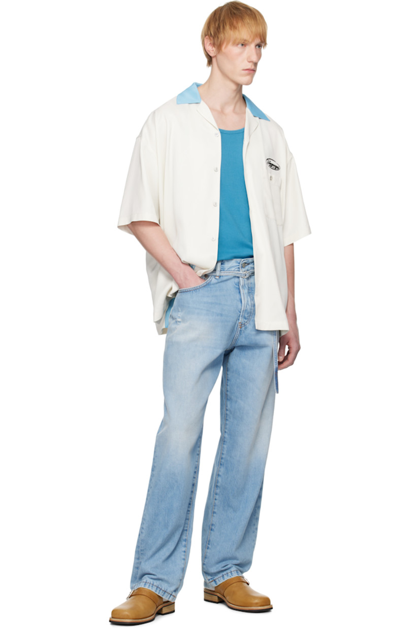 Viscose satin shirt.

· Open spread collar
· Button closure
· Logo embroidered at chest
· Patch pocket
· Logo patch at hem
· Dropped shoulders
· Vented side seams
· Logo hardware at back collar
· Twin pleats at back yoke
· Logo, graphic, and text embroidered at back

Supplier color: Ivory