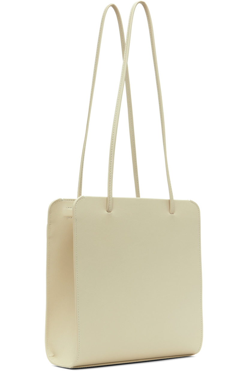 Waxed and double-tanned calfskin shoulder bag in off-white.

· Twin shoulder straps
· Patch pocket at face
· Magnetic closure
· Patch pocket at interior
· Cotton twill lining
· H10" x W9" x D3.5"

Supplier color: Tofu