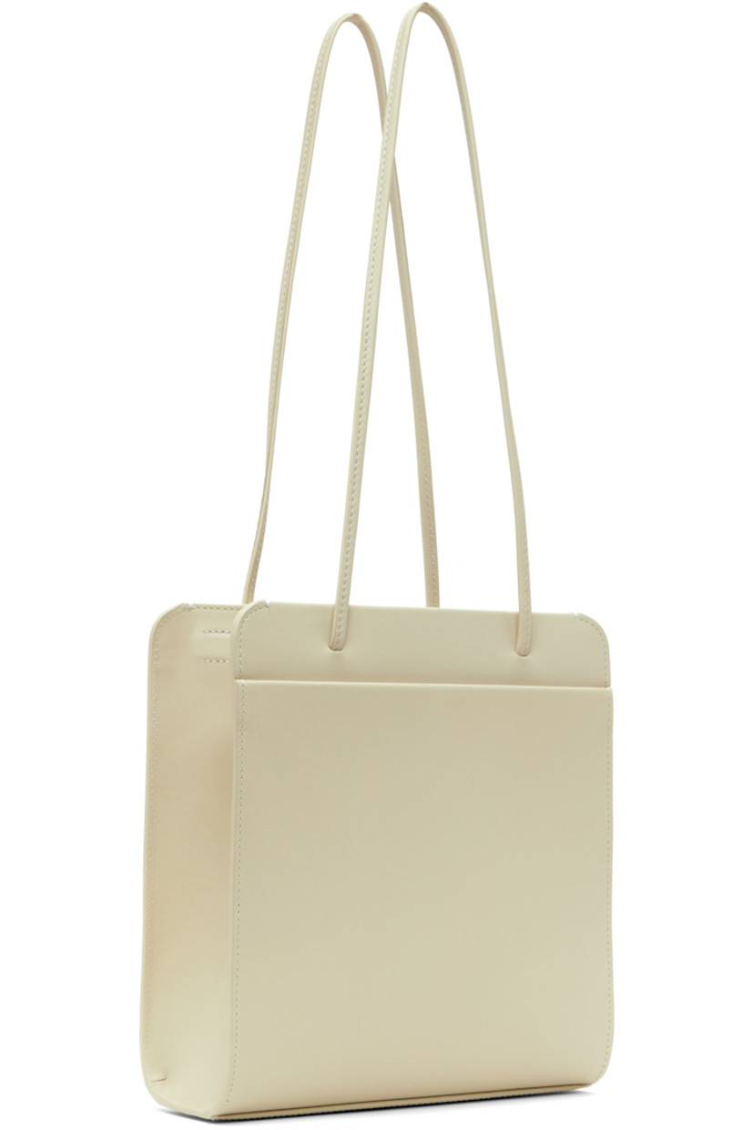 Waxed and double-tanned calfskin shoulder bag in off-white.

· Twin shoulder straps
· Patch pocket at face
· Magnetic closure
· Patch pocket at interior
· Cotton twill lining
· H10" x W9" x D3.5"

Supplier color: Tofu