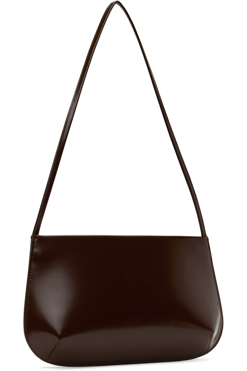 Polished spazzolato leather shoulder bag in brown. 

· Fixed shoulder strap
· Magnetic closure
· Patch pocket at interior 
· Twill lining
· H6.5" x W11.5" x D2"

Supplier color: Choc