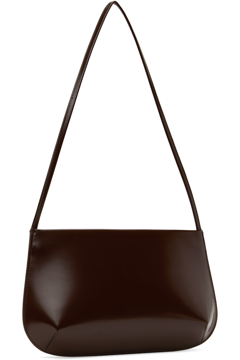 Polished spazzolato leather shoulder bag in brown. 

· Fixed shoulder strap
· Magnetic closure
· Patch pocket at interior 
· Twill lining
· H6.5" x W11.5" x D2"

Supplier color: Choc