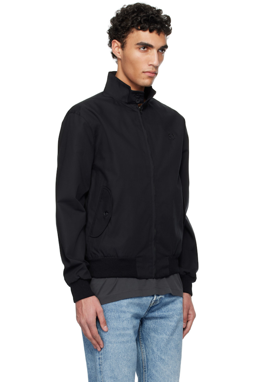 Water-resistant plain-woven polyester- and cotton-blend jacket.

· Button tab at stand collar
· Zip closure
· Logo embroidered at chest
· Flap pockets
· Rib-knit hem and cuffs
· Storm flap at back 
· Zip pocket at interior
· Tartan pattern at flannel lining

Supplier color: Black