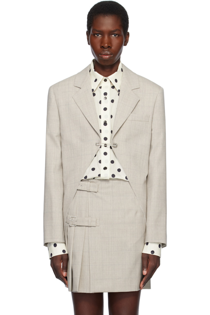 Virgin wool delaine blazer. Check pattern throughout.

· Notched lapel
· Safety-pin fastening at open front
· Welt pocket
· Padded shoulders
· Four-button surgeon's cuffs
· Central vent at back hem
· Welt pockets at interior
· Full plain-woven lining

Supplier color: Multi/Beige