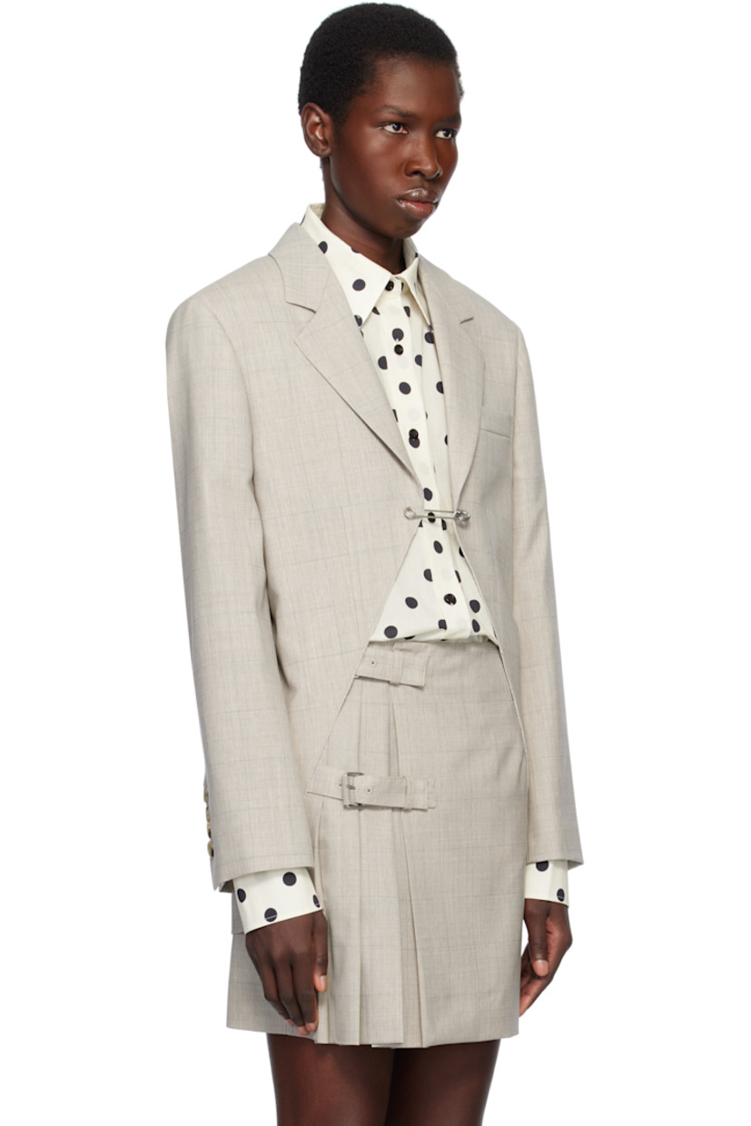 Virgin wool delaine blazer. Check pattern throughout.

· Notched lapel
· Safety-pin fastening at open front
· Welt pocket
· Padded shoulders
· Four-button surgeon's cuffs
· Central vent at back hem
· Welt pockets at interior
· Full plain-woven lining

Supplier color: Multi/Beige
