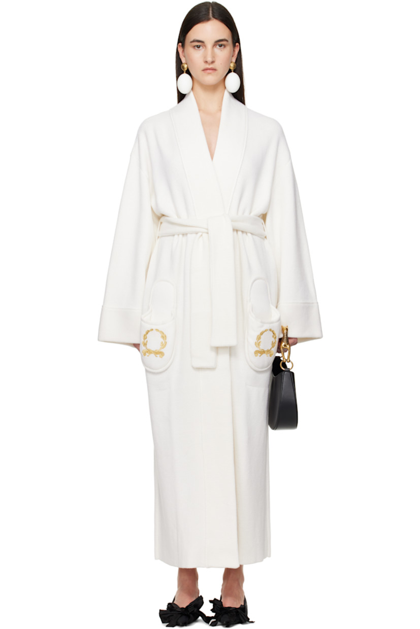 Knit nylon-blend coat. 

· Wrap construction
· Shawl lapel
· Self-tie belt at waist
· Logo graphic embroidered at graphic patch pockets
· Dropped shoulders

Supplier color: White
