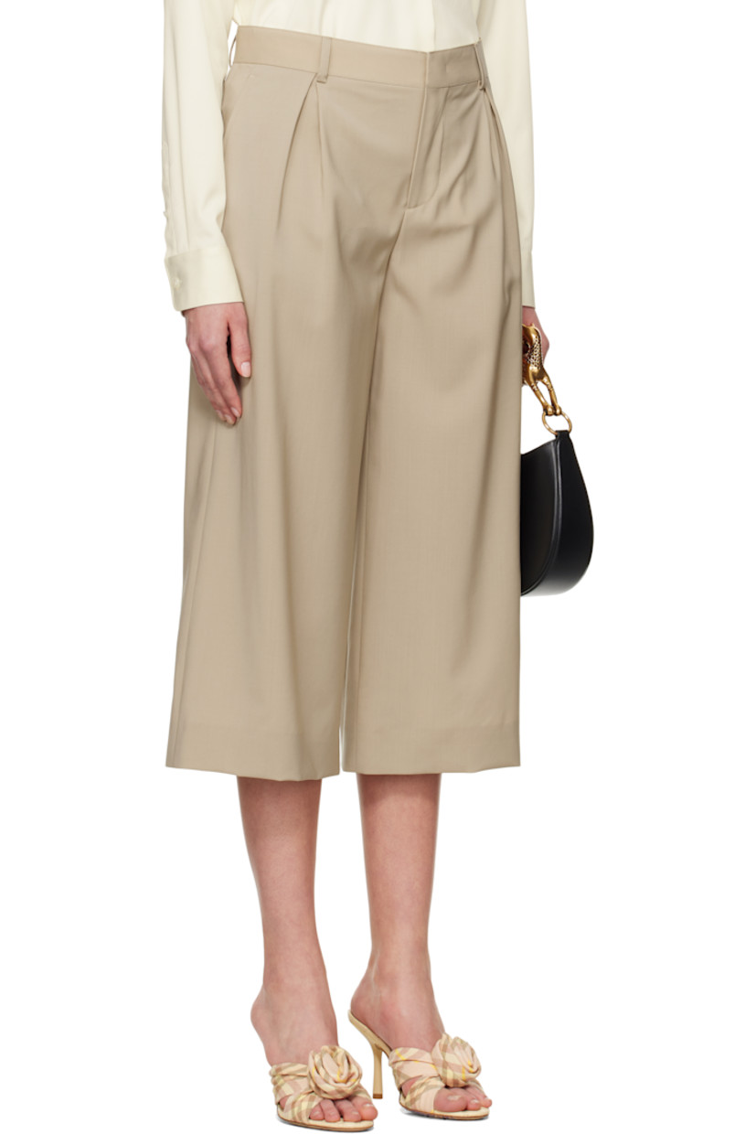 Virgin wool broadcloth trousers. 

· Belt loops
· Four-pocket styling
· Zip fly
· Inverted box pleats at front 
· Cropped legs
· Darts at back waist
· Partially lined
· Horn hardware

Supplier color: Beige
