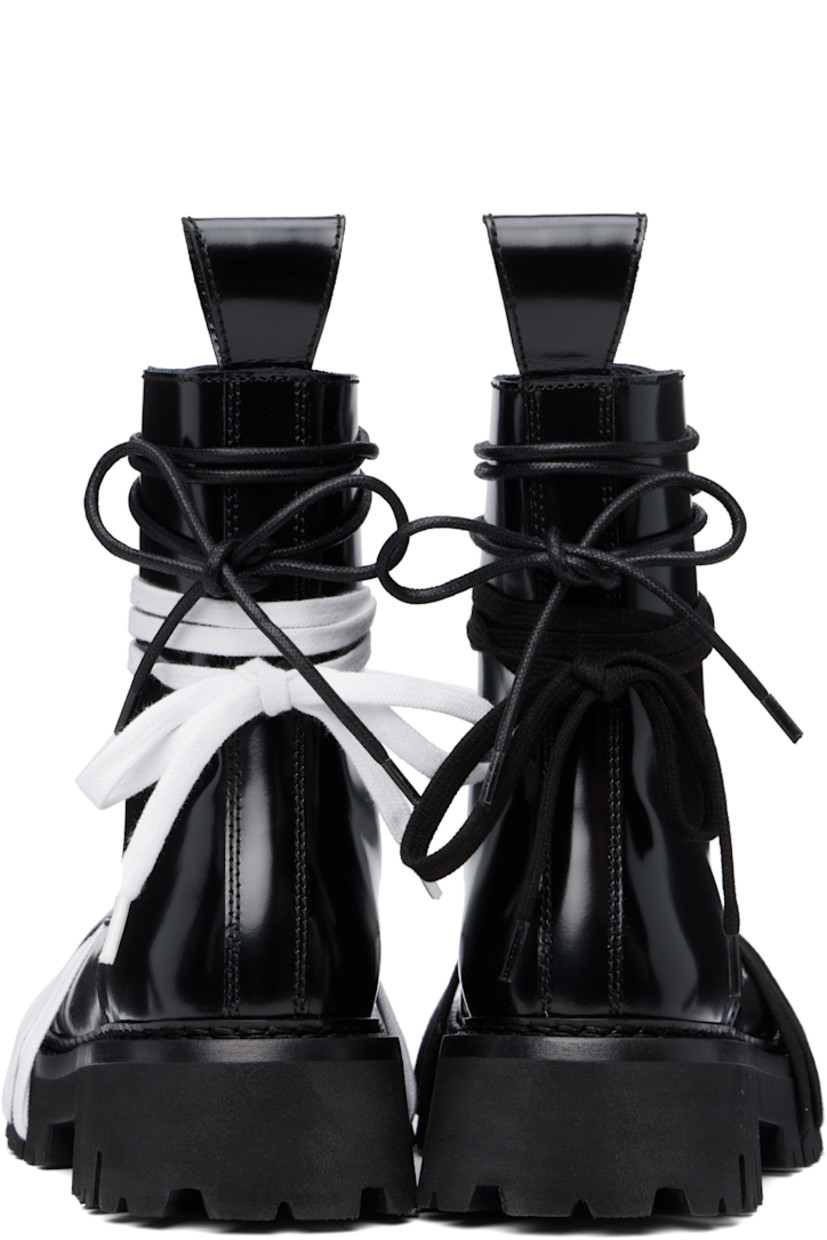 Ankle-high polished calfskin boots in black.

· Wraparound lace-up detailing at vamp and collar
· Lace-up closure
· Pull-loop at heel collar
· Topstitching at welt
· Treaded foam rubber sole

Supplier color: Black