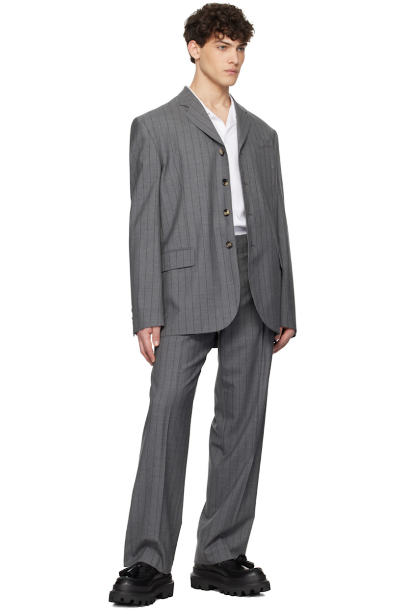 Plain-woven virgin wool blazer. Stripes throughout. 

· Notched lapel
· Button closure
· Welt pocket and flap pockets
· Padded shoulders
· Four-button surgeon's cuffs
· Vent at back hem
· Welt pockets at interior
· Fully lined

Supplier color: Multi grey