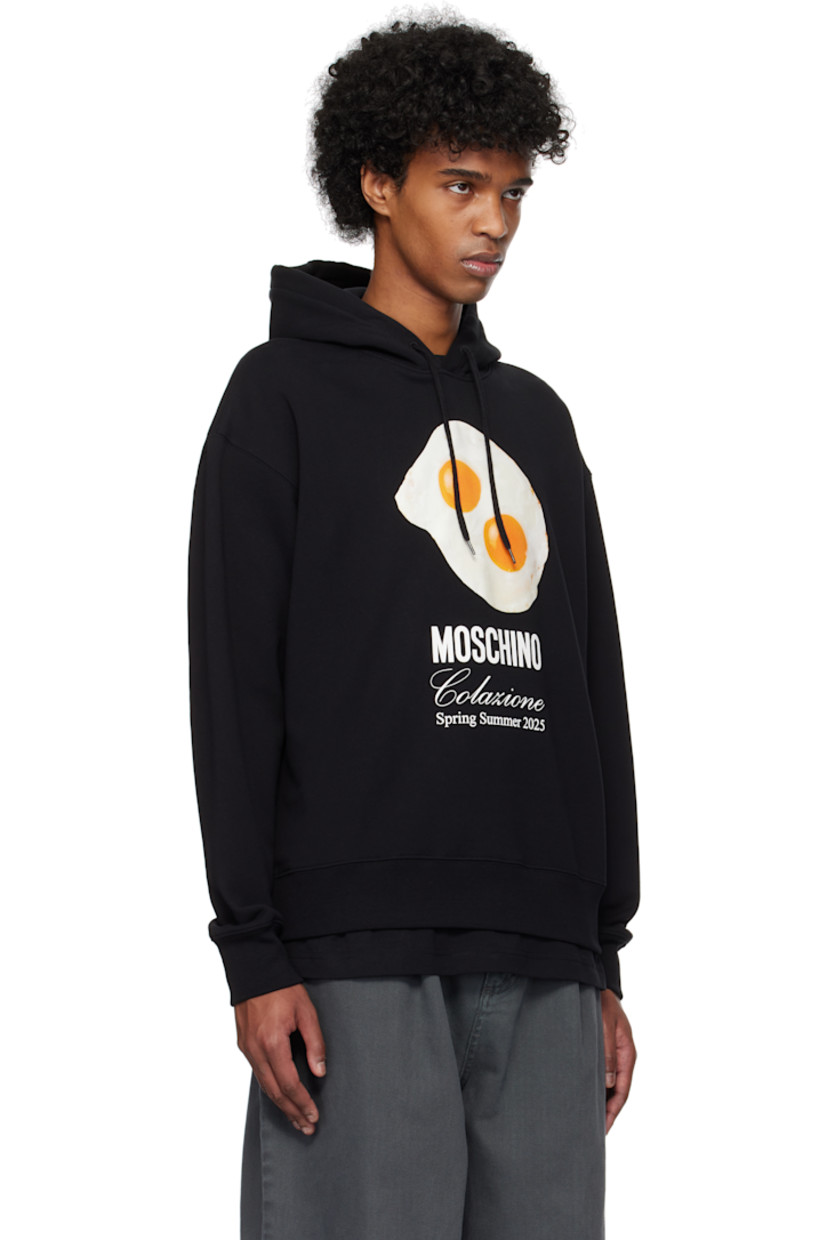 French terry hoodie. 

· Drawstring at hood
· Logo, graphic, and text printed at chest
· Rib-knit hem and cuffs 
· Dropped shoulders

Supplier color: Multi black