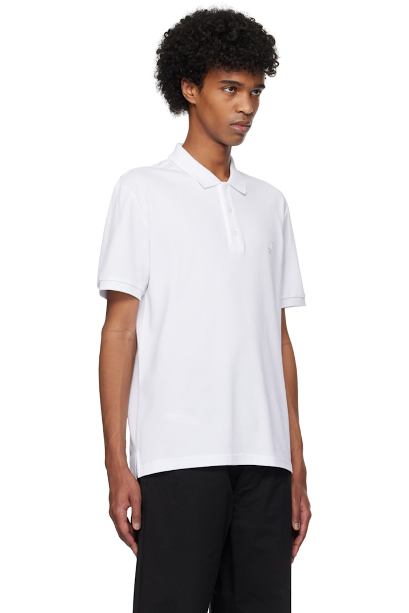 Cotton piqué polo.

· Rib-knit spread collar and cuffs
· Three-button placket
· Graphic embroidered at chest
· Tennis-tail hem

Supplier color: Multi white