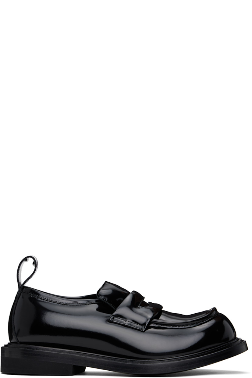 Padded patent leather loafers in black.

· Moc toe
· Strap with cutout at vamp
· Padded tongue and collar
· Pull-loop at heel tab
· Topstitching at double-welt
· Stacked leather and foam rubber block heel
· Buffed leather lining
· Leather sole

Supplier color: Black