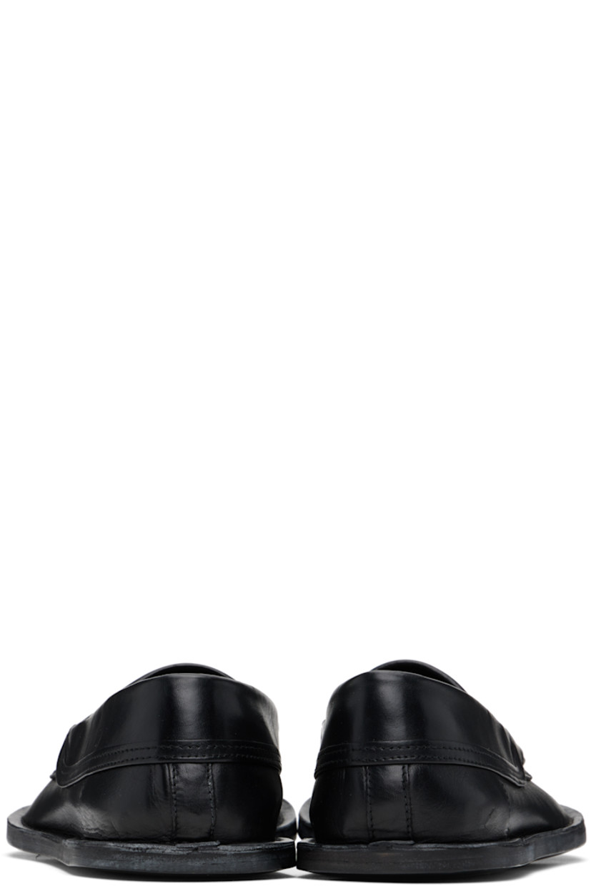 Grained calfskin loafers in black.

· Square moc toe
· Strap with cutout at vamp
· Buffed calfskin lining
· Topstitching at welt
· Polished calfskin sole

Supplier color: Black