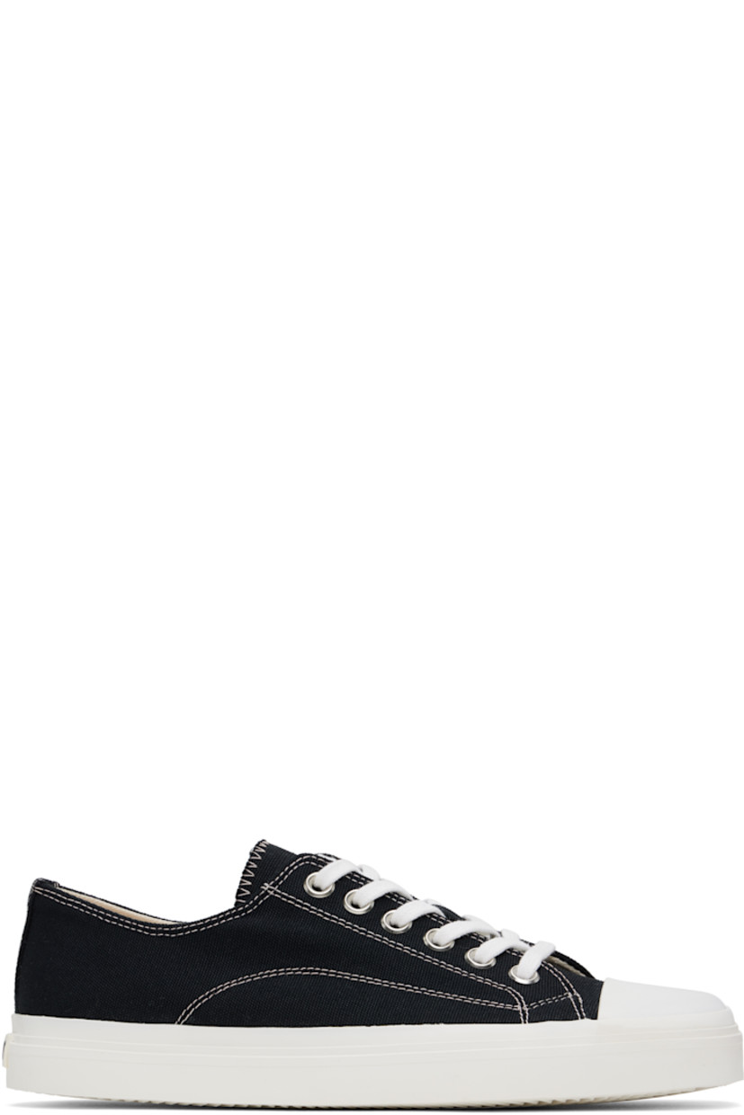 Low-top canvas sneakers in black. 

· Square rubber-cap toe
· Lace-up closure
· Rubberized logo patch at heel counter
· Twill lining
· Treaded rubber sole
· Contrast stitching in white

Supplier color: Black