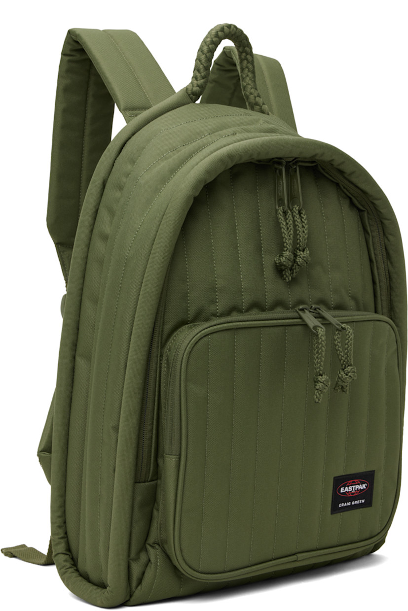 Water-resistant quilted canvas backpack in khaki. 

· Braided carry handle
· Adjustable padded shoulder straps
· Zip pocket and logo patch at face
· Two-way zip closure
· Zip pocket at interior
· Padded laptop compartment
· Canvas lining
· H17" x W14" x D4"

Part of the Craig Green x Eastpak collaboration.

Supplier color: Green