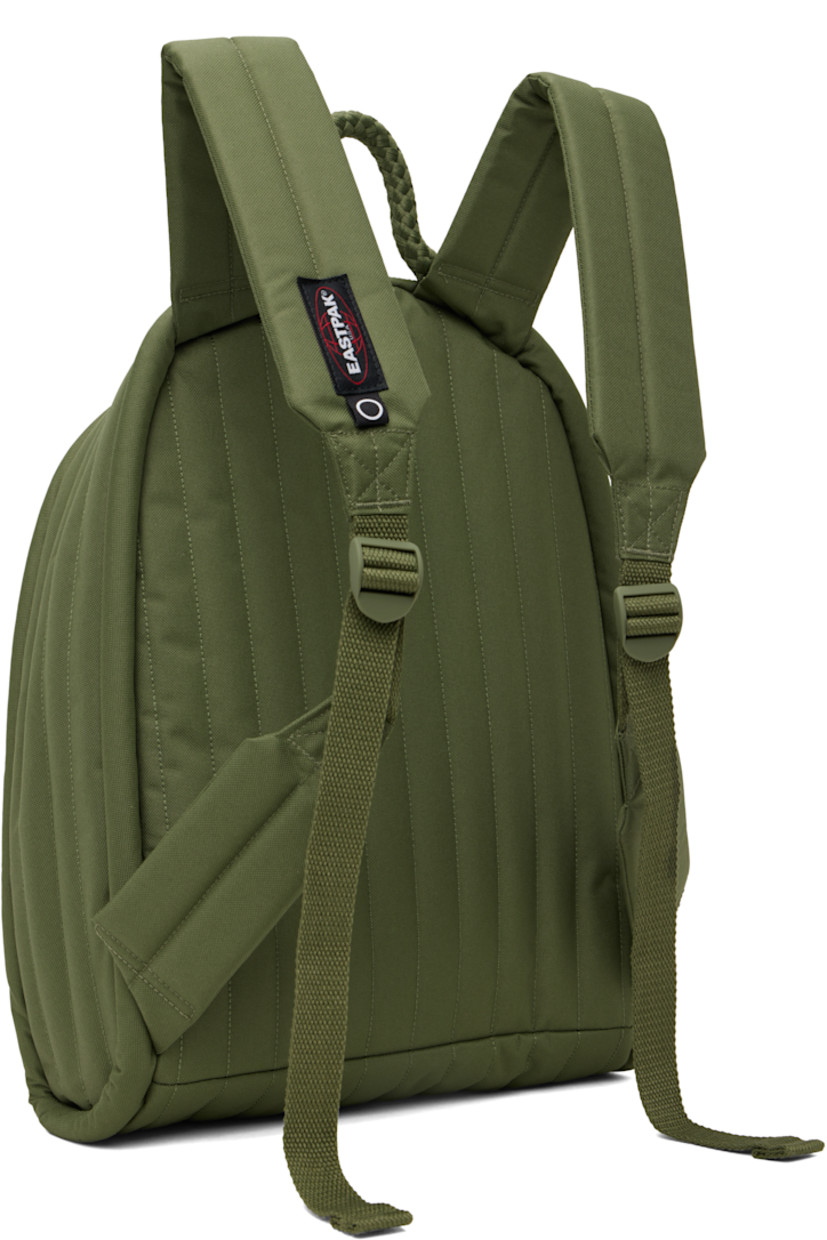 Water-resistant quilted canvas backpack in khaki. 

· Braided carry handle
· Adjustable padded shoulder straps
· Zip pocket and logo patch at face
· Two-way zip closure
· Zip pocket at interior
· Padded laptop compartment
· Canvas lining
· H17" x W14" x D4"

Part of the Craig Green x Eastpak collaboration.

Supplier color: Green