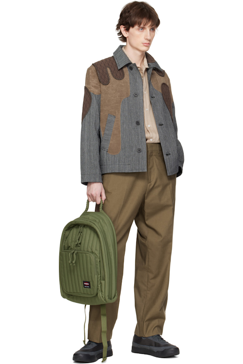 Water-resistant quilted canvas backpack in khaki. 

· Braided carry handle
· Adjustable padded shoulder straps
· Zip pocket and logo patch at face
· Two-way zip closure
· Zip pocket at interior
· Padded laptop compartment
· Canvas lining
· H17" x W14" x D4"

Part of the Craig Green x Eastpak collaboration.

Supplier color: Green