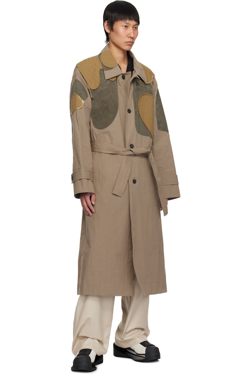 Cotton-blend poplin trench coat. Quilted patches throughout.

· Paneled construction
· Spread collar
· Button closure
· Belt loops and detachable self-tie belt
· Welt pockets
· Adjustable button tab at cuffs
· Zip pocket at interior
· Unlined

Supplier color: Beige