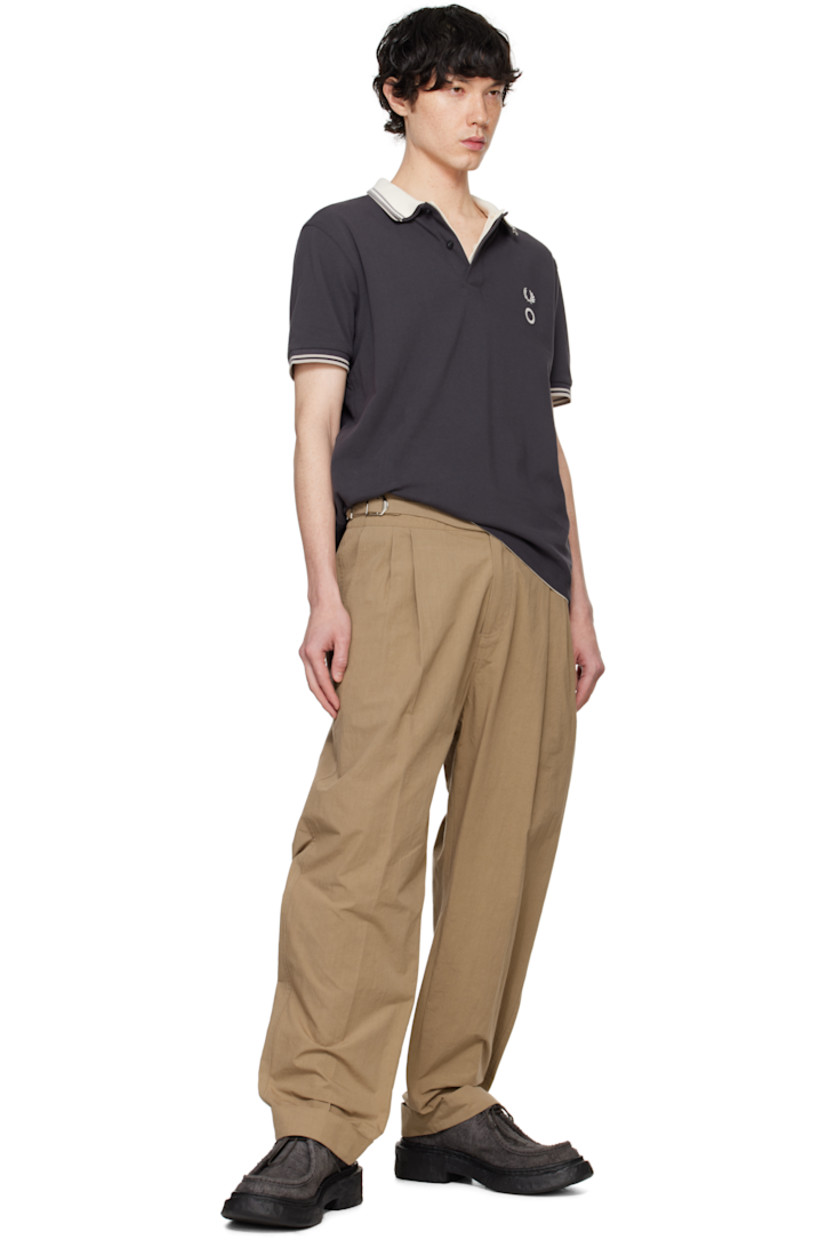 Cotton- and nylon-blend poplin trousers.

· Cinch tabs at waistband
· Four-pocket styling
· Zip-fly
· Pleats at front
· Rolled cuffs

Supplier color: Beige
