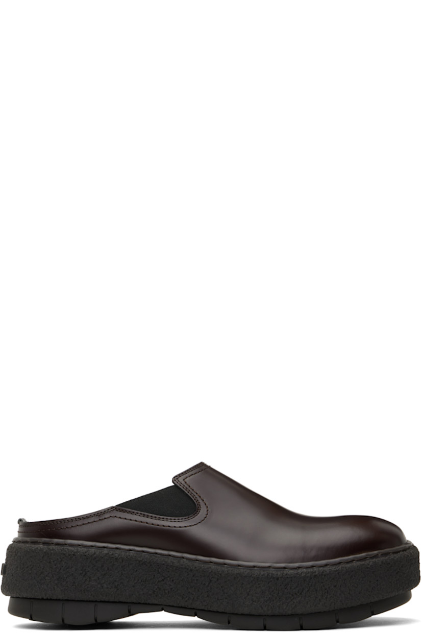 Polished leather slip-on loafers in brown.

· Square toe
· Elasticized gusset at sides
· Buffed leather lining
· Logo embossed at heel
· Crêpe rubber midsole
· Treaded rubber sole

Supplier color: Brown
