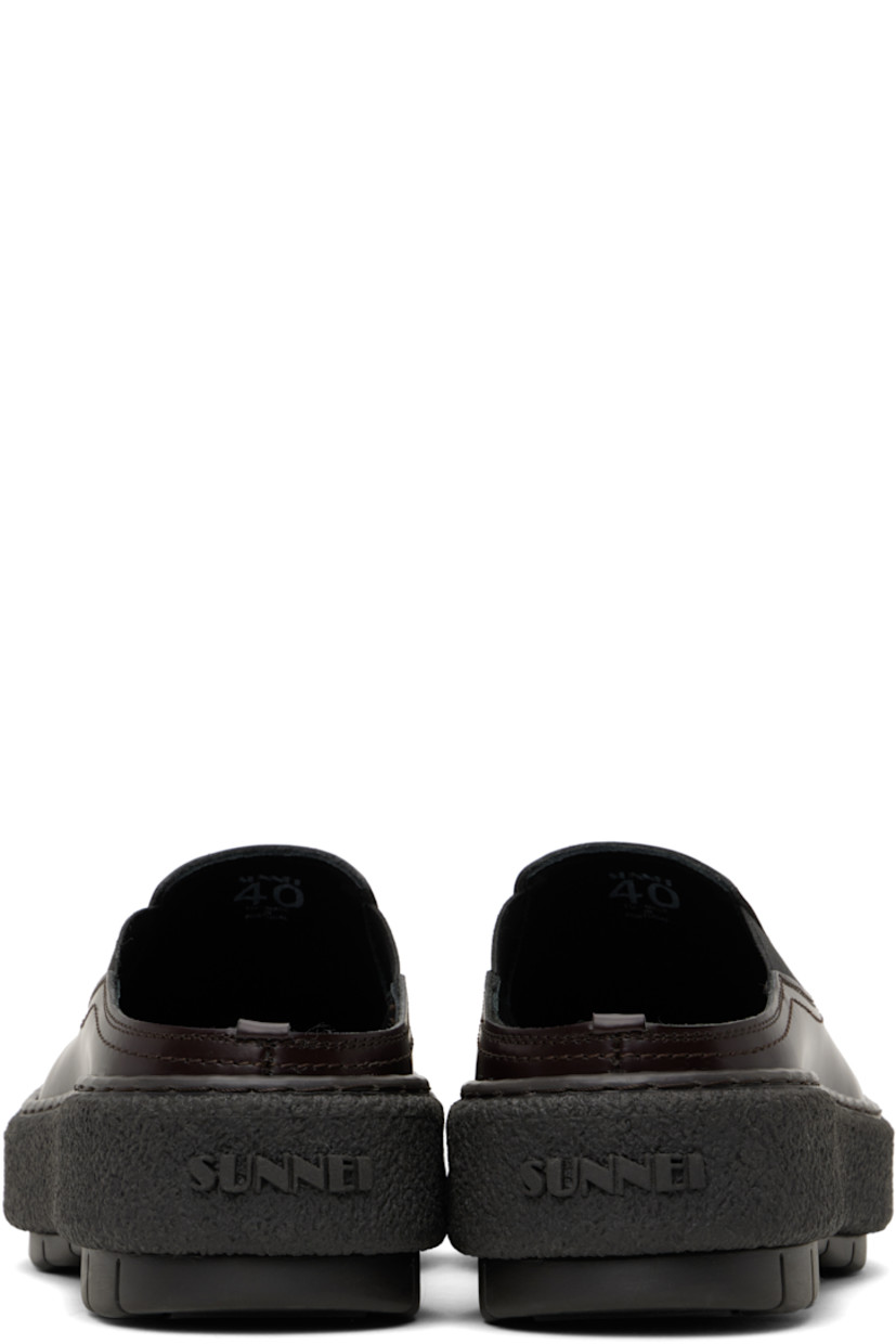 Polished leather slip-on loafers in brown.

· Square toe
· Elasticized gusset at sides
· Buffed leather lining
· Logo embossed at heel
· Crêpe rubber midsole
· Treaded rubber sole

Supplier color: Brown