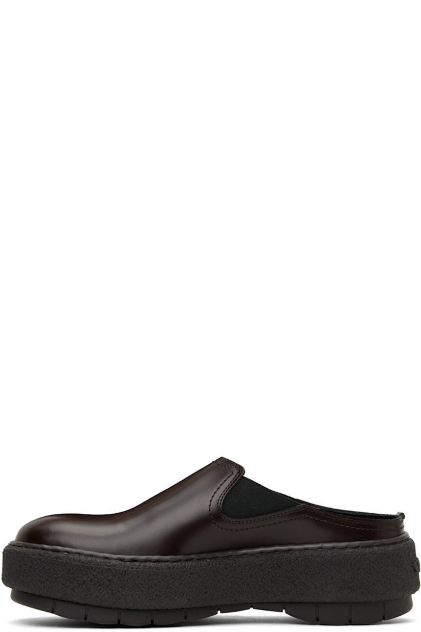 Polished leather slip-on loafers in brown.

· Square toe
· Elasticized gusset at sides
· Buffed leather lining
· Logo embossed at heel
· Crêpe rubber midsole
· Treaded rubber sole

Supplier color: Brown